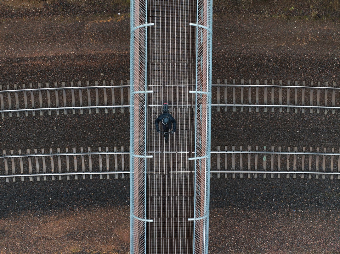 An aerial shot of a person standing at a crossroads with multiple paths, symbolizing the strategic choices in modern SEO beyond simple keywords.