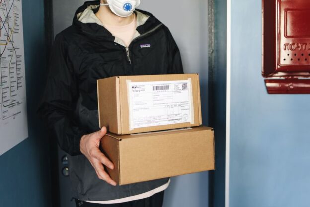 Brown cardboard package sits on the clean, modern front porch of a home, symbolizing the convenience of e-commerce delivery.