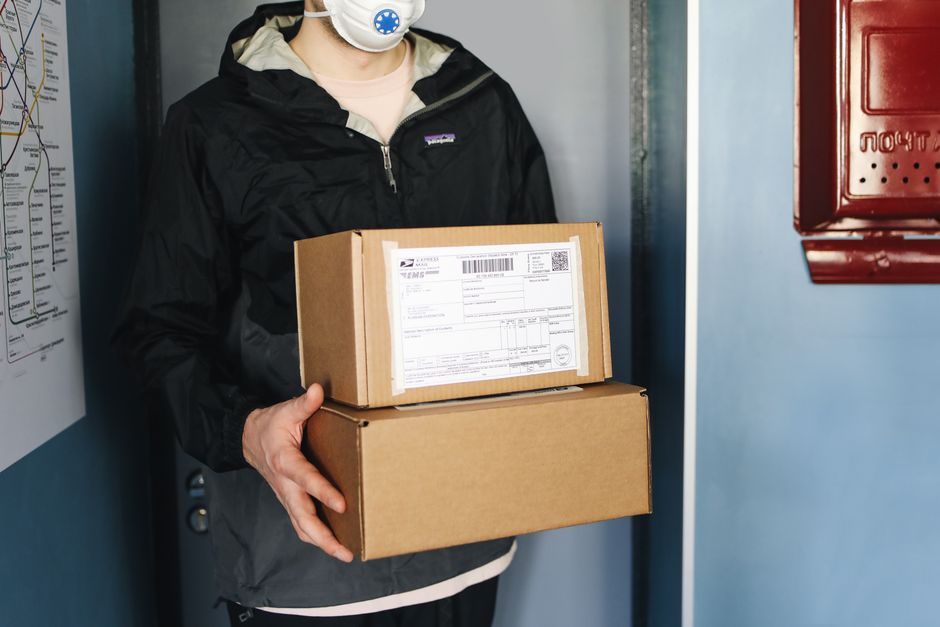 Brown cardboard package sits on the clean, modern front porch of a home, symbolizing the convenience of e-commerce delivery.