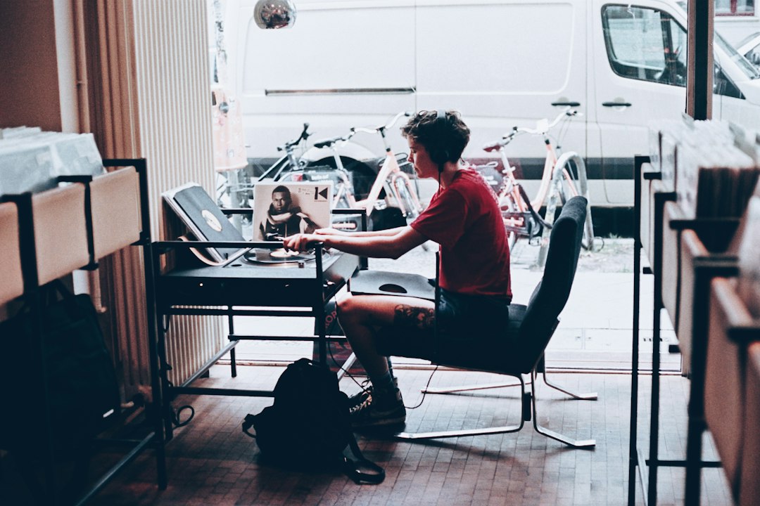 A traveler sitting comfortably with a laptop in a beautifully designed modern living room, researching their next adventure.